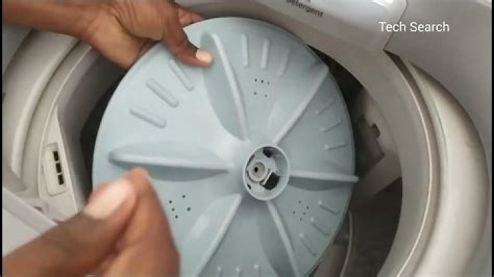 How do you clean a top loader washing machine drum?
